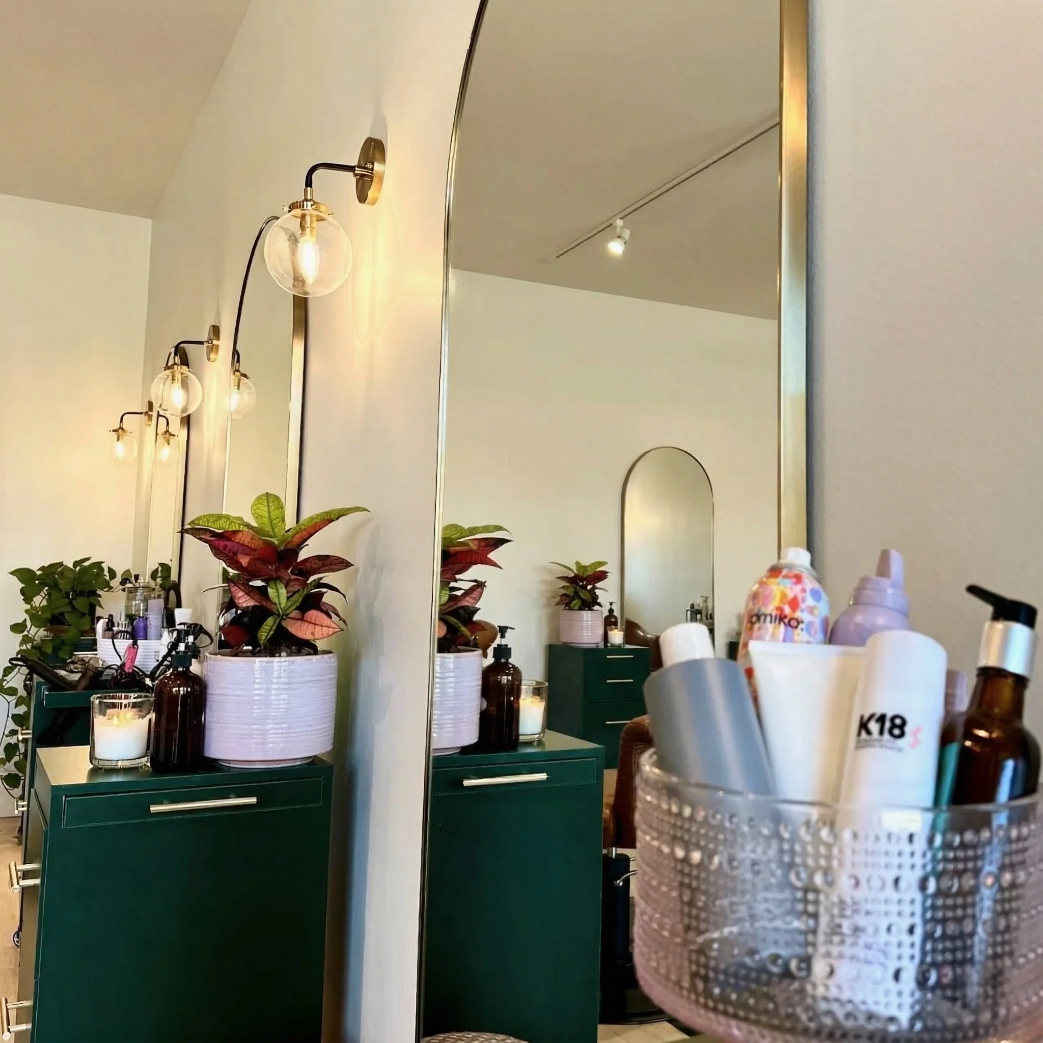 Mirror detail with plants and warm lighting